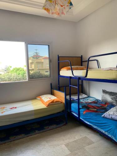 Postel nebo postele na pokoji v ubytování Appartement RESIDENCE « RAYANE BEACH »