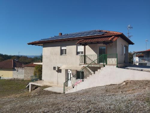a house with solar panels on the roof at Villa Platania in Palaiokómi