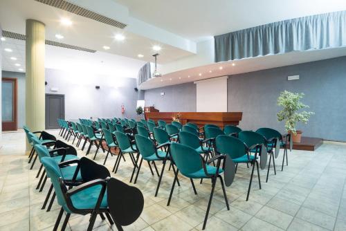 a room with a bunch of chairs and a podium at Terra Umbra Hotel in Narni