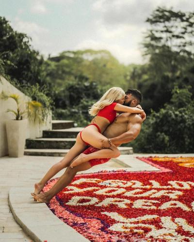 a woman in a red dress hugging a man at Villa Cella Bella Ubud in Ubud