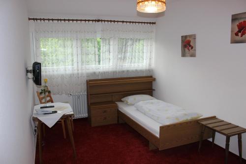 ein kleines Schlafzimmer mit einem Bett und einem Fenster in der Unterkunft Gasthof Krone in Schuttertal