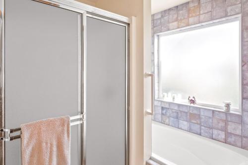 a bathroom with a shower with a glass door at Belfair Beach House in Belfair