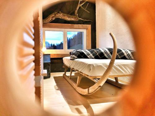 a view of a bedroom with a bed and a mirror at Ferienhaus Bergträumli Keine Zufahrt in Gommiswald