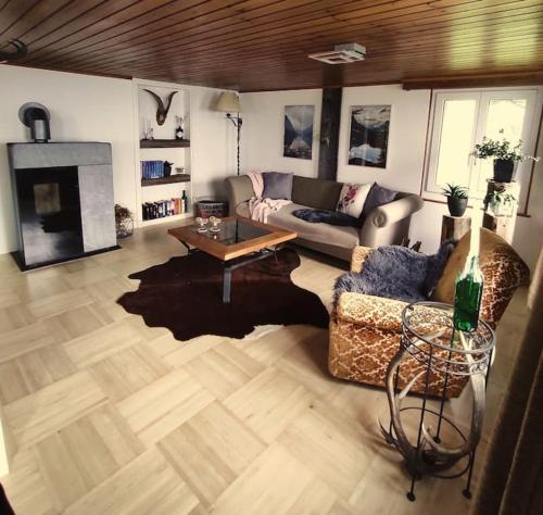 a living room with a couch and a table at Ferienhaus Bergträumli (Keine direkte Zufahrt) in Gommiswald