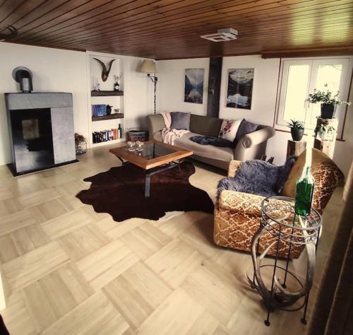 a living room with a couch and a table at Ferienhaus Bergträumli Keine Zufahrt in Gommiswald