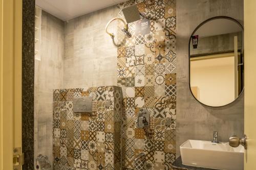 a bathroom with a sink and a mirror at Olive Koramangala 4th Block by Embassy Group in Bangalore