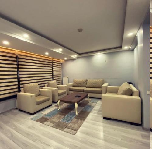 a living room with couches and a coffee table at Tk Kurdal Suit in Samsun