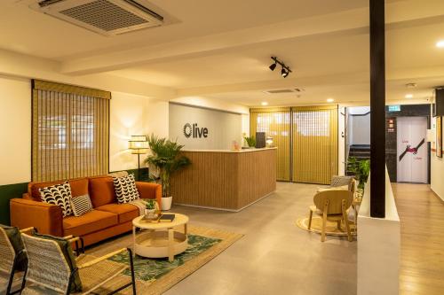an office lobby with a couch and a table at Olive Koramangala 4th Block by Embassy Group in Bangalore