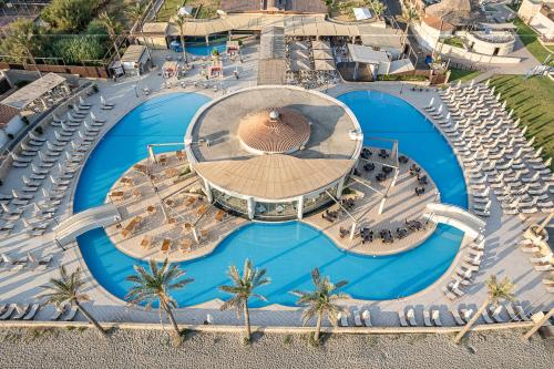 an overhead view of a swimming pool with a resort at Caldera Beach in Plataniás
