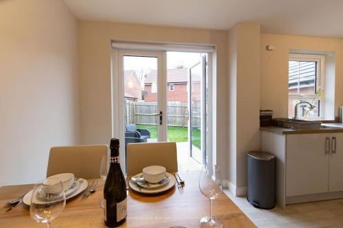 a kitchen with a table with a bottle of wine at Cosy Home in Picturesque Village Cottingham in Cottingham
