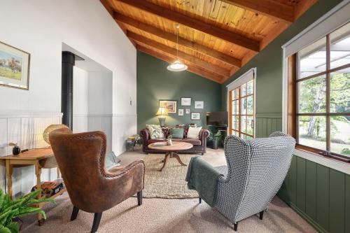 a living room with two chairs and a couch at Jamieson Cottages - Cottage 1 in Howqua