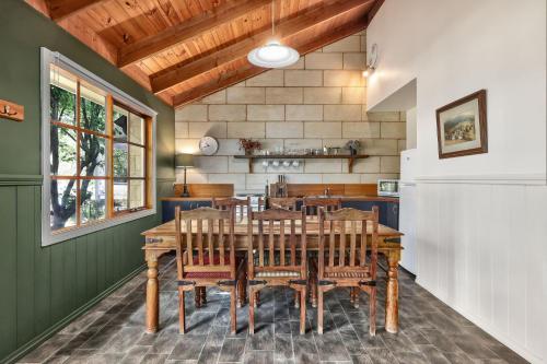 a dining room with a wooden table and chairs at Jamieson Cottages - Cottage ONE - Sleeps 4 in Howqua