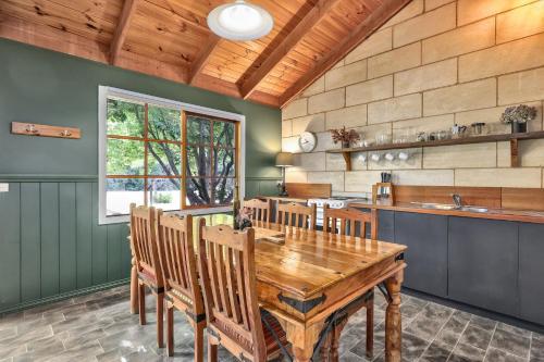 a dining room with a wooden table and chairs at Jamieson Cottages - Cottage ONE - Sleeps 4 in Howqua