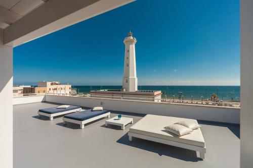 a lighthouse on the roof of a building with beds at Casa del Faro in Torre Canne