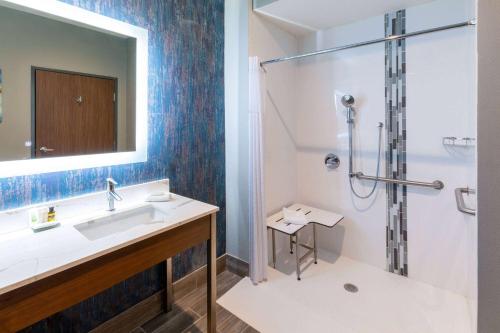 a bathroom with a sink and a shower at La Quinta Inn & Suites by Wyndham Dallas - Frisco Stadium in Frisco