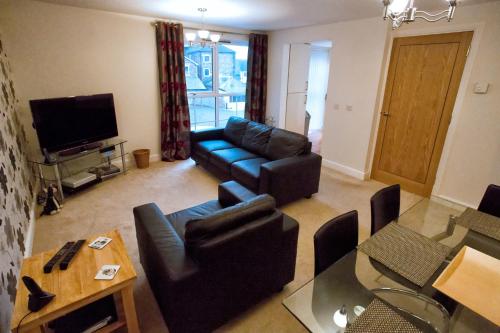 a living room with a couch and a tv at Salisbury Luxury Apartment in Salisbury