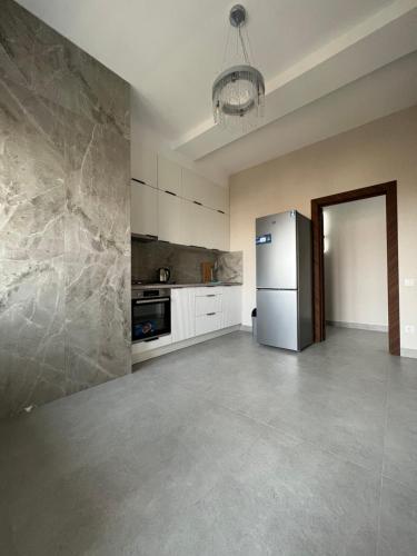 een lege keuken met een koelkast in een kamer bij Platinum in Bisjkek