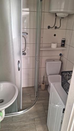 a bathroom with a shower and a toilet and a sink at Apartment for 6 people with parking near beach Trstenik in Split