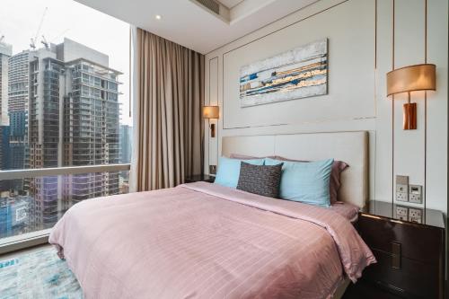 a bedroom with a large bed and a large window at Luxury 2BR Designer Suite above Pavilion Mall in Kuala Lumpur