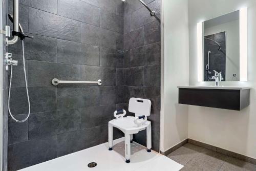 a bathroom with a shower and a toilet and a sink at Sleep Inn & Suites Fort Walton Beach - Destin West in Fort Walton Beach
