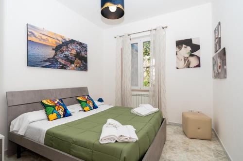 a bedroom with a bed with towels on it at Divina suite Cavaliere in Maiori
