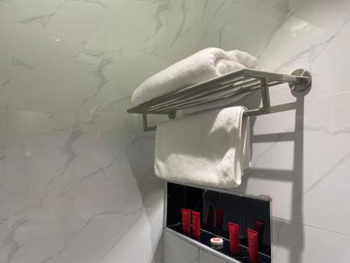 a towel rack in a bathroom with white marble walls at فيرانو - Virano in Riyadh