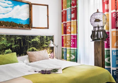 a bedroom with a bed and some books at Boutiquehotel Stadthalle in Vienna