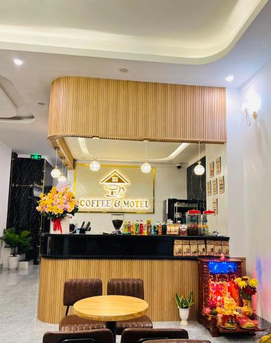 a coffee shop with a table and a coffee counter at HATY MOTEL & COFFEE in Pleiku