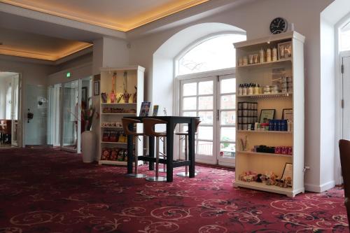 a room with a table and shelves of items at Milling Hotel Saxildhus in Kolding