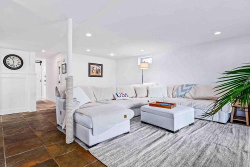 a white living room with a white couch and a table at Riverview Retreat On Warehouse Creek in Edgewater