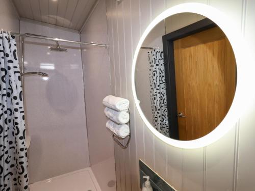 a bathroom with a mirror and a shower at Famau in Mold