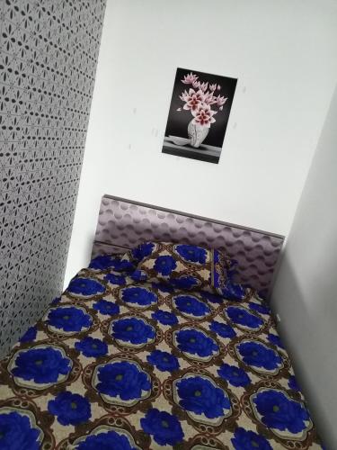 a bedroom with a bed with blue flowers on it at Short rest, long rest and vacation holidays in Abu Dhabi