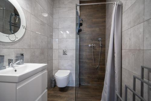 a bathroom with a shower and a toilet and a sink at Szafir in Wrzosowo