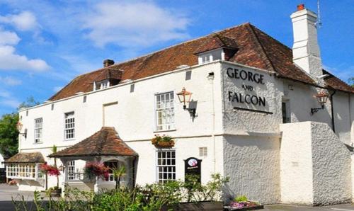 a white building with a sign on it at George & falcon in Southampton