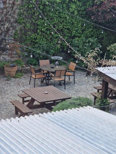 a picnic table and chairs in a backyard at Ring O Bells in Chagford