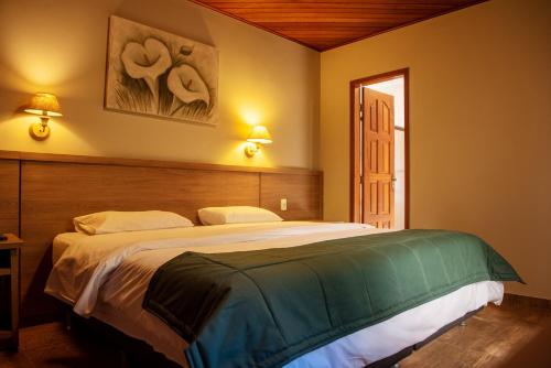 Ένα ή περισσότερα κρεβάτια σε δωμάτιο στο Hotel Vila Verde