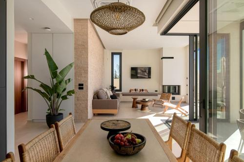 a living room with a table with a bowl of fruit at Anantia Villa 1 - Scenic View, Luxury Experience in Episkopi (Heraklion)
