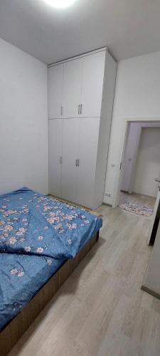 a bedroom with a bed and white cabinets at New Luxury 1st Story with balcony - 3 rooms 1 bathroom kitchen tv-wifi -city in Ferizaj