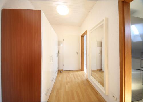 an empty room with a hallway with a mirror at Ferienwohnungen Roseninsel & Perle in Feldafing