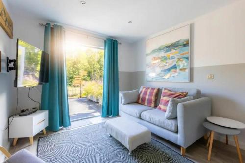 a living room with a couch and a window at 2 Bedrooms overlooking Little Petherick Creek in Little Petherick