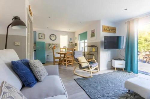 a living room with a couch and a tv at 2 Bedrooms overlooking Little Petherick Creek in Little Petherick