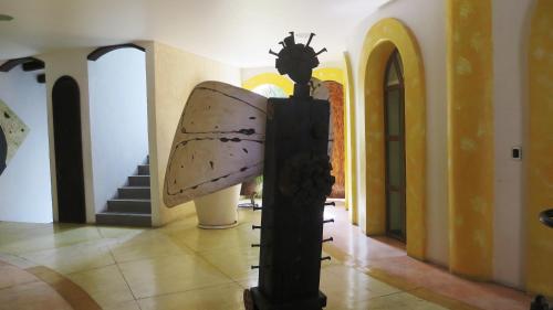 a statue of a butterfly in a hallway at Mansion Tepotzotlan in Tepotzotlán