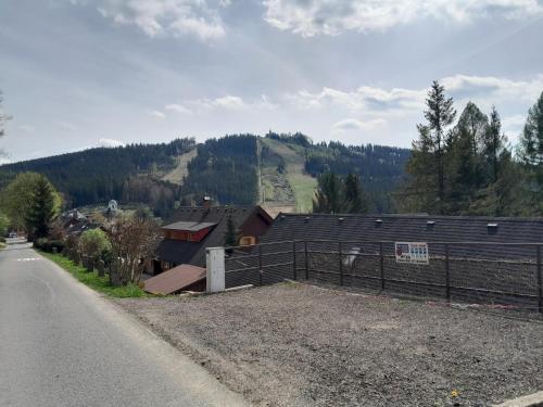 a house with a fence on the side of a road at Albrechtice Jizerky in Albrechtice v Jizerských horách
