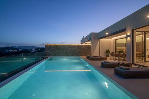 a swimming pool in front of a house at Anantia Villa 1 - Scenic View, Luxury Experience in Episkopi (Heraklion)