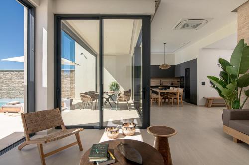 an open living room with sliding glass doors at Anantia Villa 1 - Scenic View, Luxury Experience in Episkopi (Heraklion)