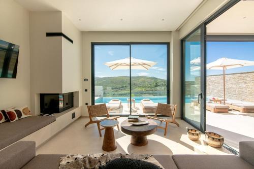 a living room with a couch and a table at Anantia Villa 1 - Scenic View, Luxury Experience in Episkopi (Heraklion)