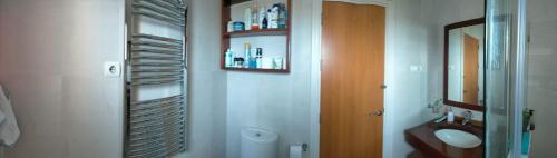 a bathroom with a mirror and a sink in it at Habitacion en casa particular con vista al mar in Cala del Moral