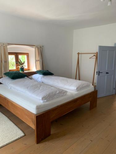 two beds in a room with a bed frame at Am Schafhof in Velburg