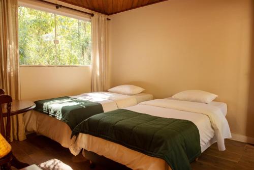 Ένα ή περισσότερα κρεβάτια σε δωμάτιο στο Hotel Vila Verde