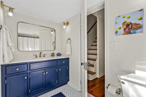a bathroom with a blue sink and a mirror at Fisher House - Downtown Annapolis! in Annapolis